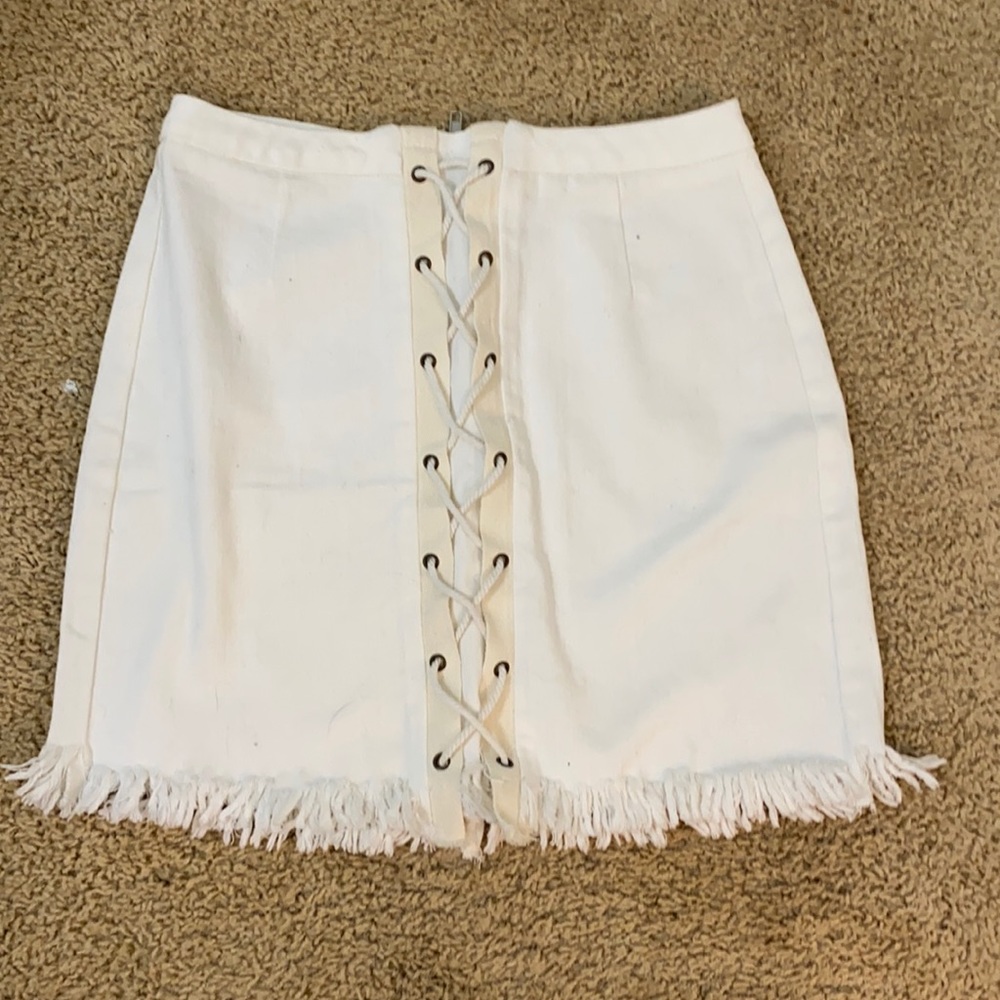 White denim skirt! Cris cross down the front and distressed bottom. Size medium